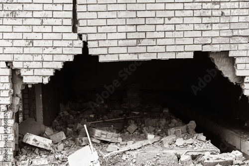 Building Exterior Wall Cracked Damaged Closeup abstract background sepia black and white photograph. photo