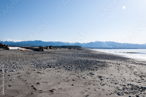 Wooden trunks and pebbles at Dungeness Spit, Olympic Peninsula, USA