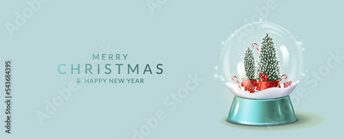 Christmas and New Year greeting card with transparent snow globe with fir trees  and snow.	