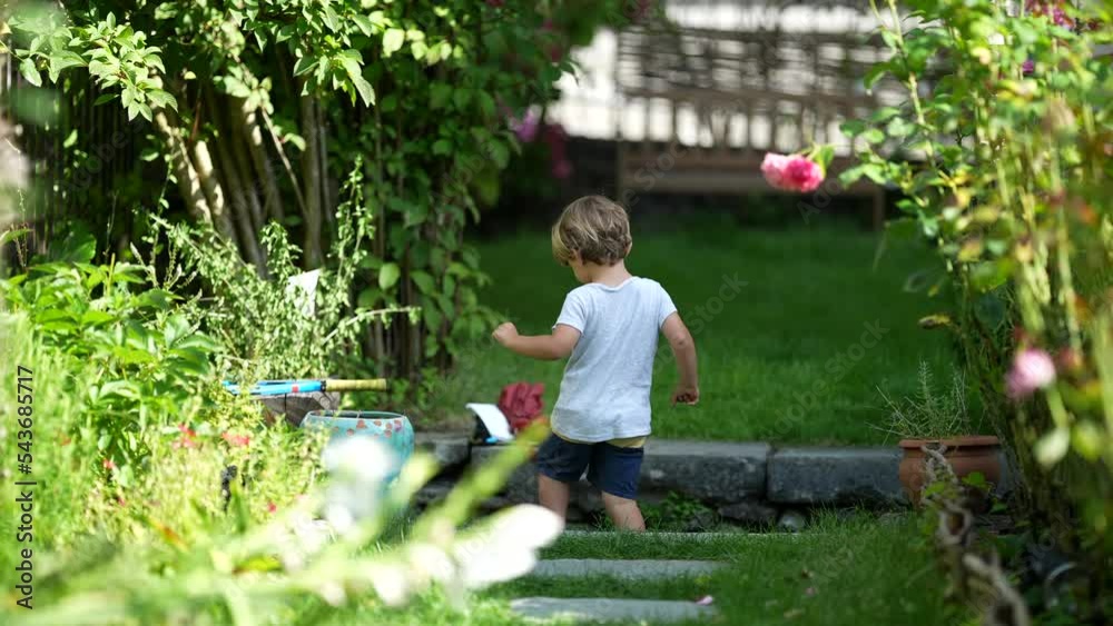 One candid little boy exploring house backyard garden One candid little boy exploring house backyard garden