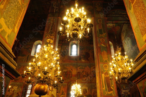 Beautiful ornate painted interior of Orthodox Church. Old frescoes with icons inside luxury Russian cathedral. Moscow