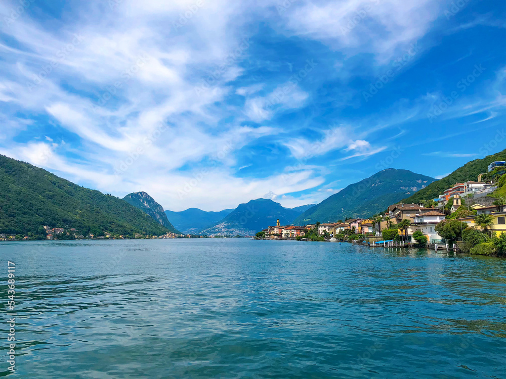 Panoramic view of the ancient lakeside village of Brusino Arsizio, located at the foot of Monte San Giorgio, on the shores of Lake Lugano, Ticino, Switzerland. 