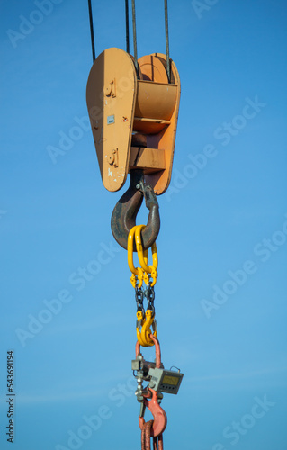 gantry crane with hook against blue sky 