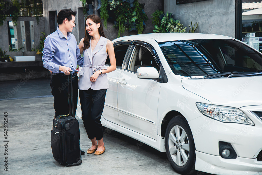 Asian couple preparing a car and luggage for traveling. Asian couple preparing a car and luggage for traveling.