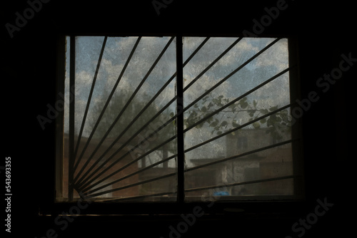 Window in building. Single window. Light in dark interior. Glass in evening. photo