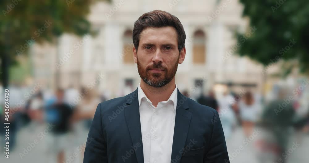 Portrait of man standing in the background of time-lapse of a crowded street Portrait of man standing in the background of time-lapse of a crowded street