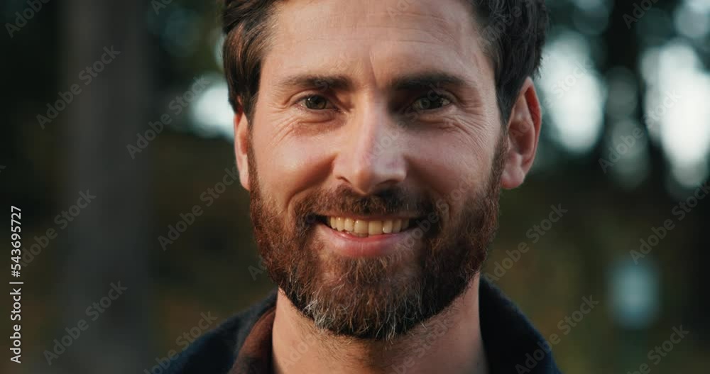 Portrait of a middle-aged man looks into the camera and smiling Portrait of a middle-aged man looks into the camera and smiling