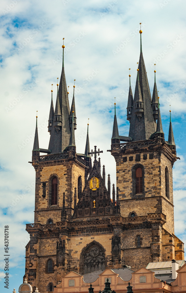 Double towers of Church of Our Lady before Tyn  in Old Town ,Prague, Czech Republic. Looking up with blue sky and white clouds beyond..