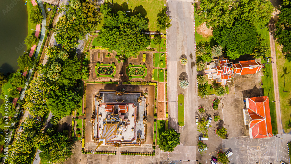 Drone aerial view , traveler with backpack traveling into beautiful pagoda in Wat Chalong or Chalong temple at Phuket town, Thailand. It's most popular thai temple in Phuket Thailand.