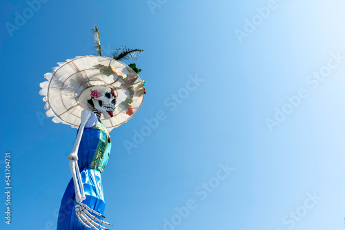 Huge skull and crossbones with regional Mexican dress for traditional Day of the Dead festivities called Catrina