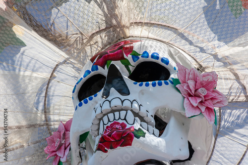 Huge skull and crossbones with regional Mexican dress for traditional Day of the Dead festivities called Catrina