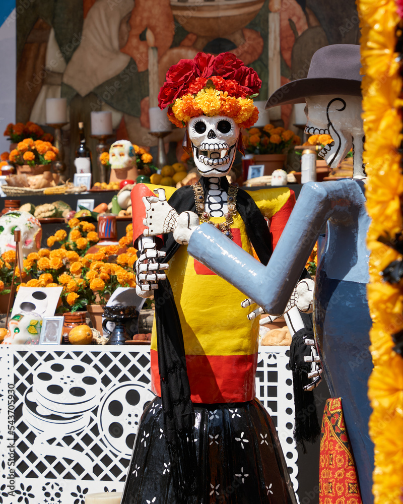 Fototapeta premium multicolored day of the dead skulls, day of the dead with bones and figures of paper and traditional mexican clay