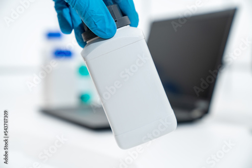 Plastic container for chemicals in science lab on computer background.Jar for chemicals with space for text online shopping chemicals
