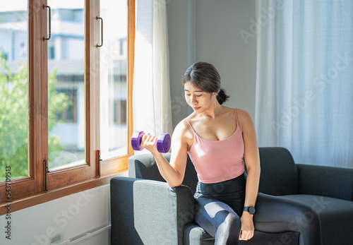 Asian woman exercising using dumbbells Beautiful woman practicing yoga, meditating, indoors at home, wearing sportswear, taking a full body photo and practicing meditation. healthy lifestyle Free Download Asian woman exercising using dumbbells Beautiful woman practicing yoga, meditating, indoors at home, wearing sportswear, taking a full body photo and practicing meditation. healthy lifestyle - GFXLoad