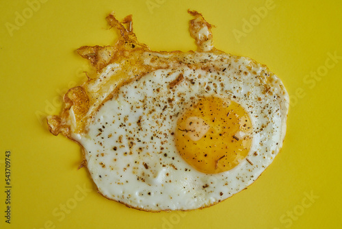 Fried egg on yellow background