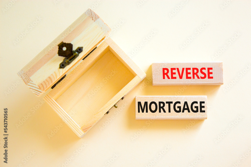 Reverse mortgage symbol. Concept words Reverse mortgage on wooden blocks. Beautiful white table white background. Empthy wooden chest. Business and reverse mortgage concept. Copy space. Reverse mortgage symbol. Concept words Reverse mortgage on wooden blocks. Beautiful white table white background. Empthy wooden chest. Business and reverse mortgage concept. Copy space.