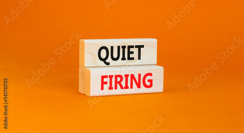 Quiet firing symbol. Concept words Quiet firing on wooden blocks. Beautiful orange table orange background. Business and quiet firing concept. Copy space.