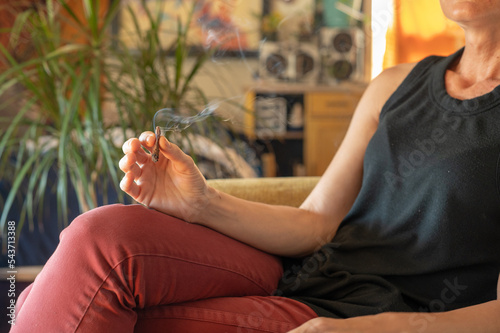 Photography Woman seen sitting and smoking cannabis