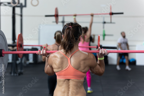 Fitness Workout at Gym: Girls doing Exercises in Class with Barbells