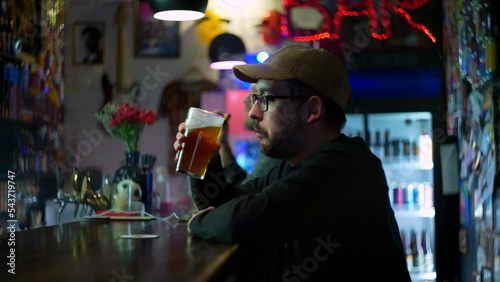 White an drinking beer in the bar in slow motion