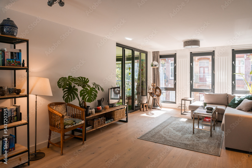 Fototapeta premium Beautiful and large living room interior with hardwood floors and white ceiling in new home