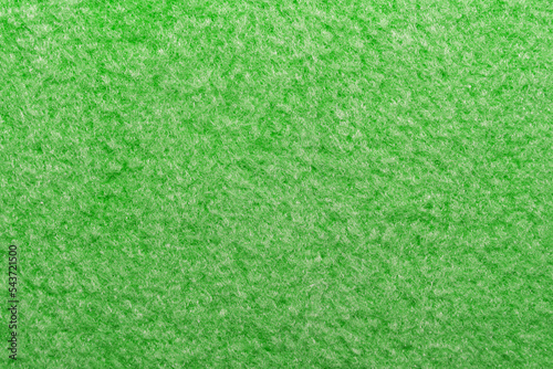 Luxurious green fabric with fibers and pile. Textile. Velveteen material