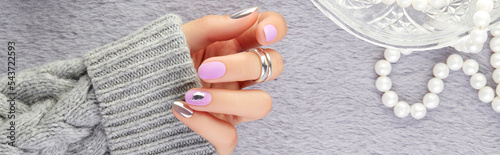 Womans hand with trendy lavender manicure. Fashion clothes and accessories