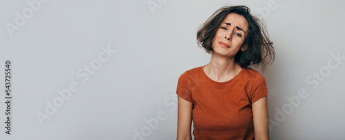 Close up shot of screaming crazy frustrated woman with anxiety, anger and depression. Very upset and emotional woman crying. Young girl with angry and furious face. Human expressions and emotions