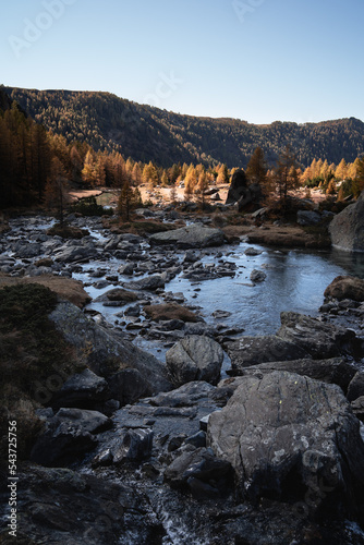 A small lake at the end of the river that crosses the flats of Predarossa, Northern Italy photo