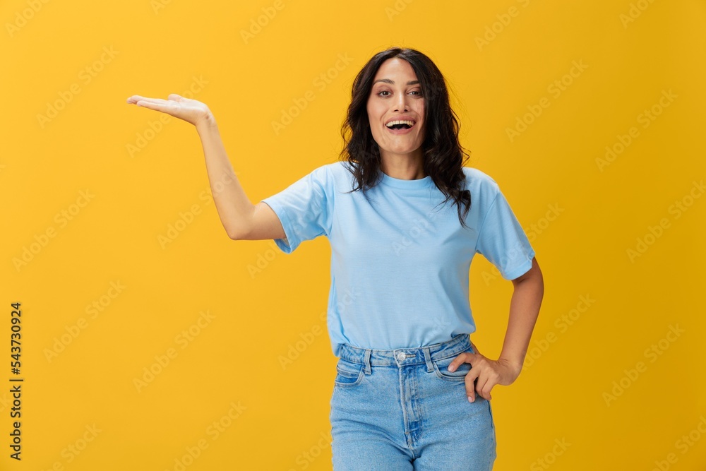 Woman signal smile with teeth emotion portrait in blue t-shirt on yellow background, hands up, surprise, lifestyle, copy space Woman signal smile with teeth emotion portrait in blue t-shirt on yellow background, hands up, surprise, lifestyle, copy space