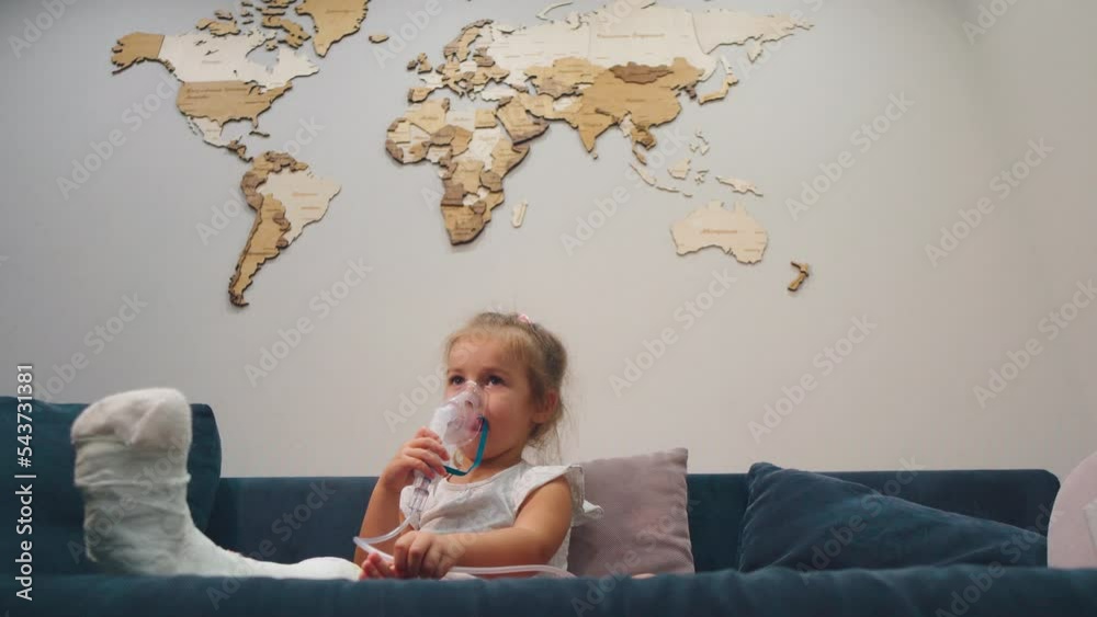 A child with a broken leg takes a cough inhalation. Beautiful map of