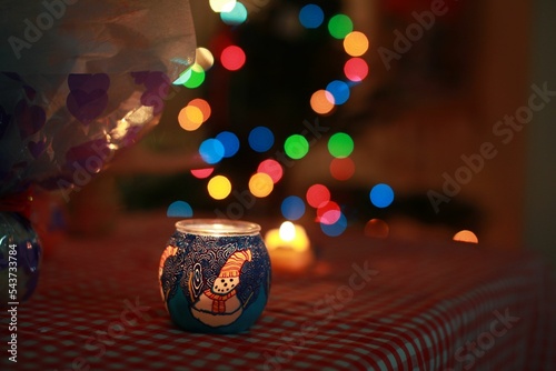 Beautiful shot of Christmas candle with blurred lights background