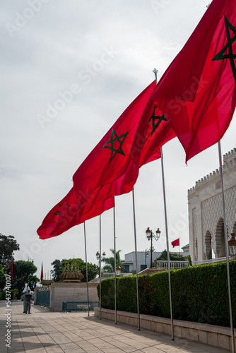 Moroccan flags fluttering with a cloudy sky in the background