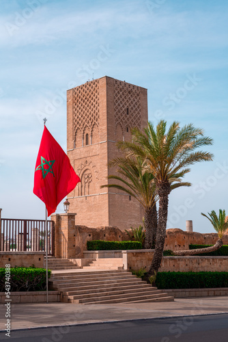 Moroccan flag fluttering and the Hassan tower in the background in Rabat