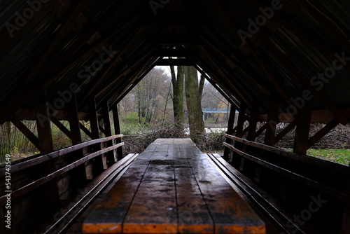 Panorama frame Eating area inside the pavilion of a park with view of trees and cloudy sky