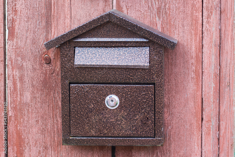 Mailbox on a wooden fence close-up