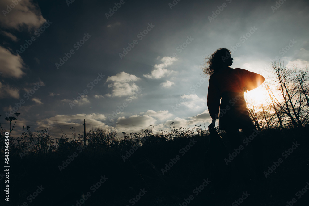 silhouette of a girl against the sky