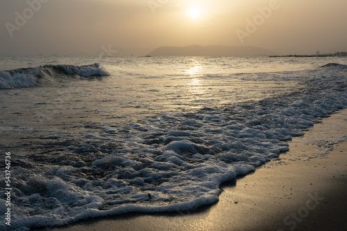 Sea. Beautiful golden sunset on the Mediterranean coast with unusual lighting through the air haze