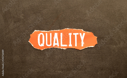 QUALITY word written on red torn paper photo