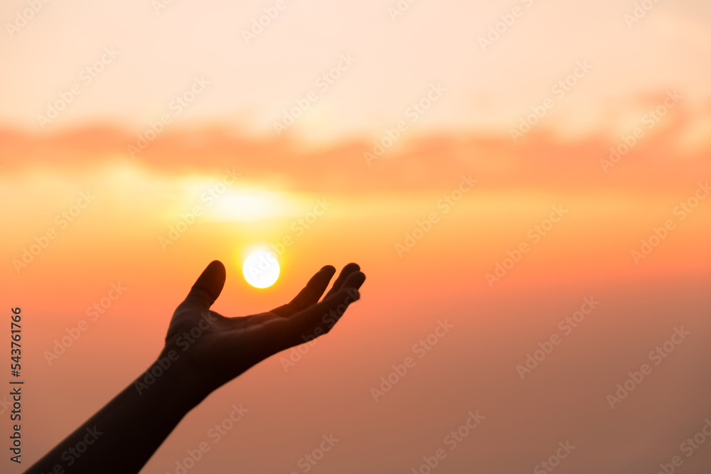 Silhouette of woman hand praying spirituality and religion, female worship to god. banner with copy space. Religious people are humble to God. Christians have hope faith and faith in god.