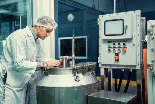 Portrait of a scientist, apothecary extracting cannabis oil using scientific equipment in a laboratory. Concept of cannabis extraction for alternative medicinal treatment. CBD oil extraction concept.