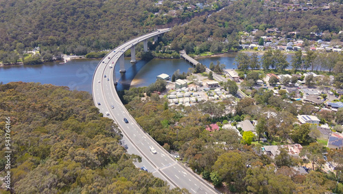 Aerial drone view of Woronora River Bridge across Woronora River in the Sutherland Shire, Southern Sydney, NSW, with vehicles traveling across the structure     