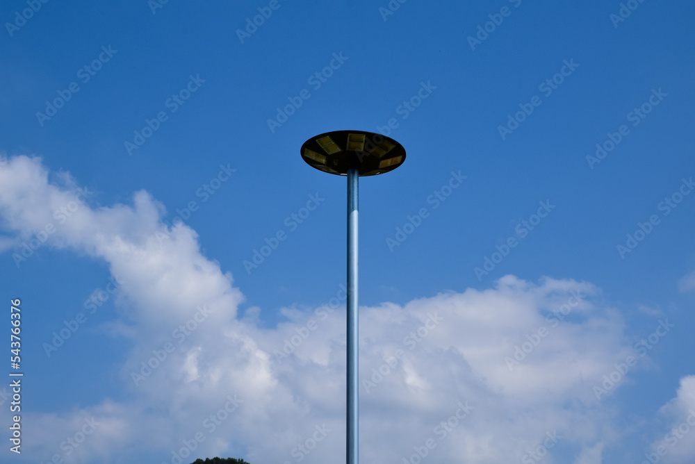 Mini lamp post for lighting at night powered by a solar panel on top of the lamp was installed near wooden walkway or pathway of a homestay, sustainable energy and environmental friend concept. Mini lamp post for lighting at night powered by a solar panel on top of the lamp was installed near wooden walkway or pathway of a homestay, sustainable energy and environmental friend concept.