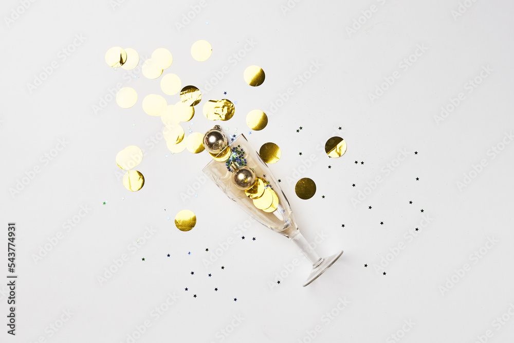 gold confetties and confetties on a white surface with confetties scattered around it gold confetties and confetties on a white surface with confetties scattered around it