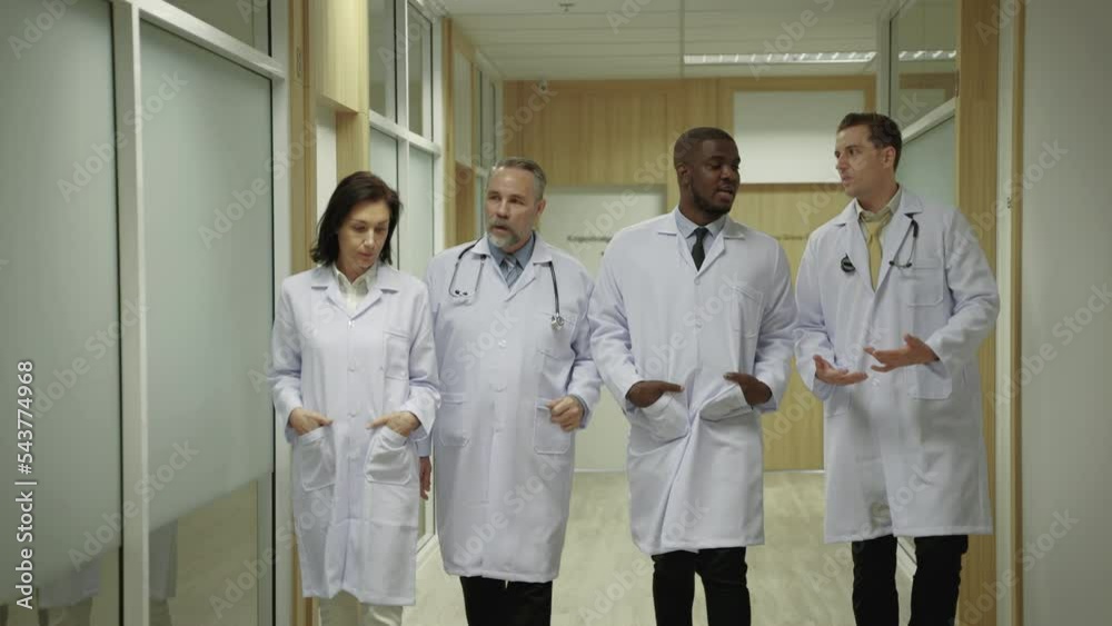 team of doctors are walking and discussing in the corridors of the hospital.
team of doctors are walking and discussing in the corridors of the hospital.