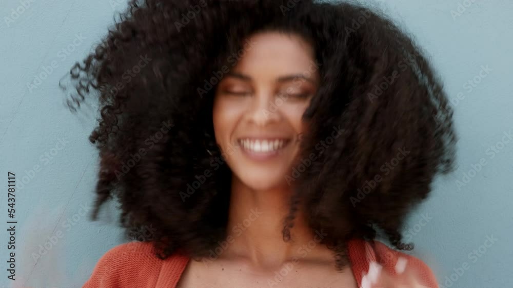 Afro woman portrait in curly natural hairstyle for empowerment, carefree and funky look on blue wall background and mockup. Cool, hair care black woman with retro hair style and a big cheerful smile Afro woman portrait in curly natural hairstyle for empowerment, carefree and funky look on blue wall background and mockup. Cool, hair care black woman with retro hair style and a big cheerful smile