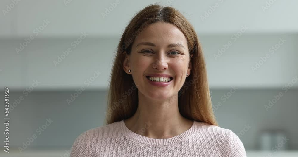 Happy pretty 30s Caucasian woman posing at home, looking at camera with toothy smile. Beautiful lady with natural makeup, healthy white teeth head shot portrait Happy pretty 30s Caucasian woman posing at home, looking at camera with toothy smile. Beautiful lady with natural makeup, healthy white teeth head shot portrait