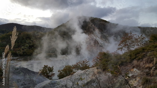 Noboribetsu Onsen Picnic Site, Japan. Hot spring with steam and mountain.
