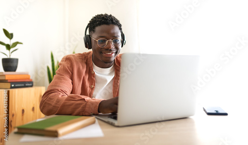 E-learning concept. Teen African American college student taking online lessons.Panoramic image.