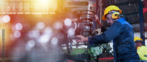 Professional industrial engineer, technician, factory worker wear hard hat, safety glasses. While checking, set up, control machine heavy industry factory. Employee working in manufacturing facility.